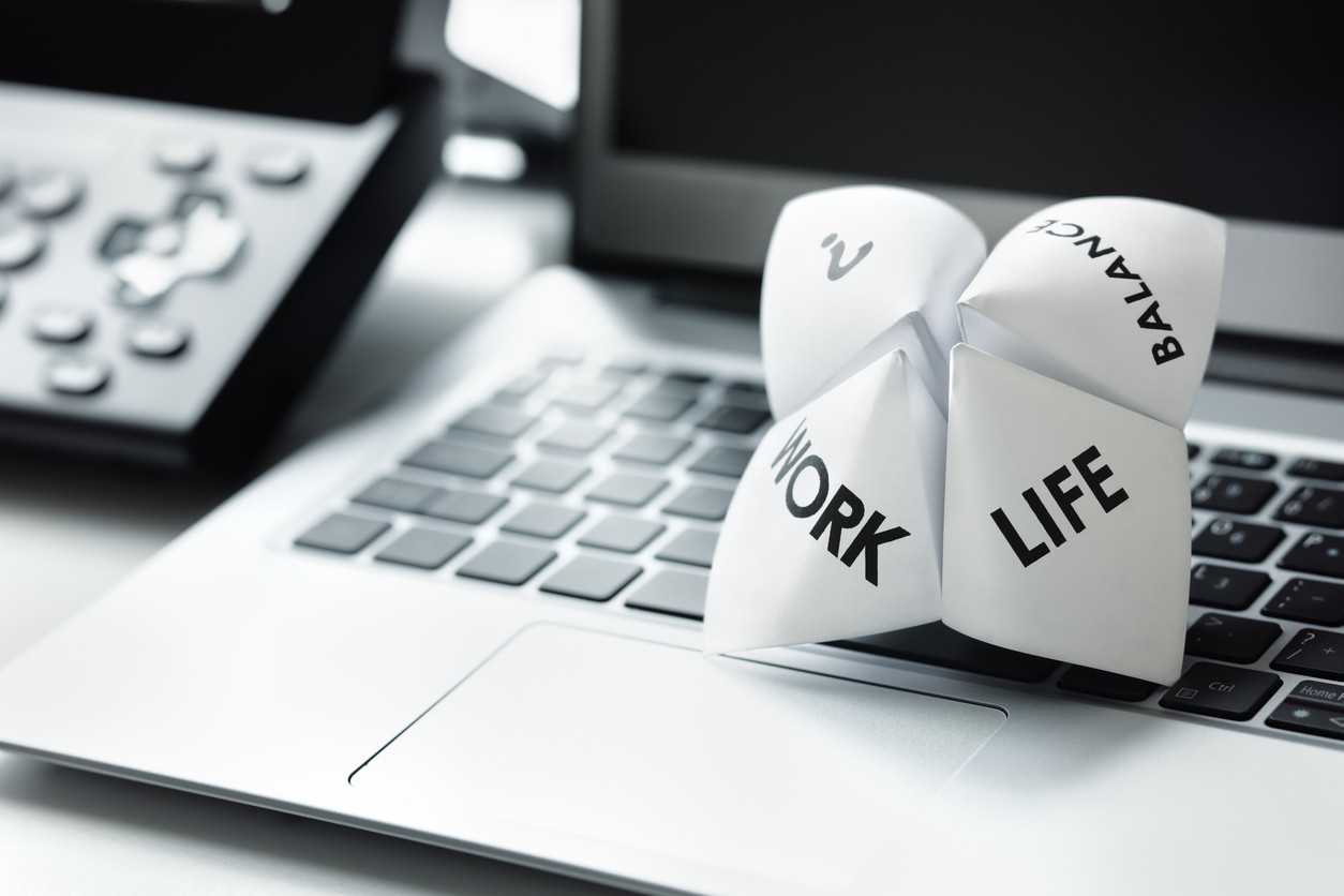 Laptop keyboard with paper, life, work, balance, selector